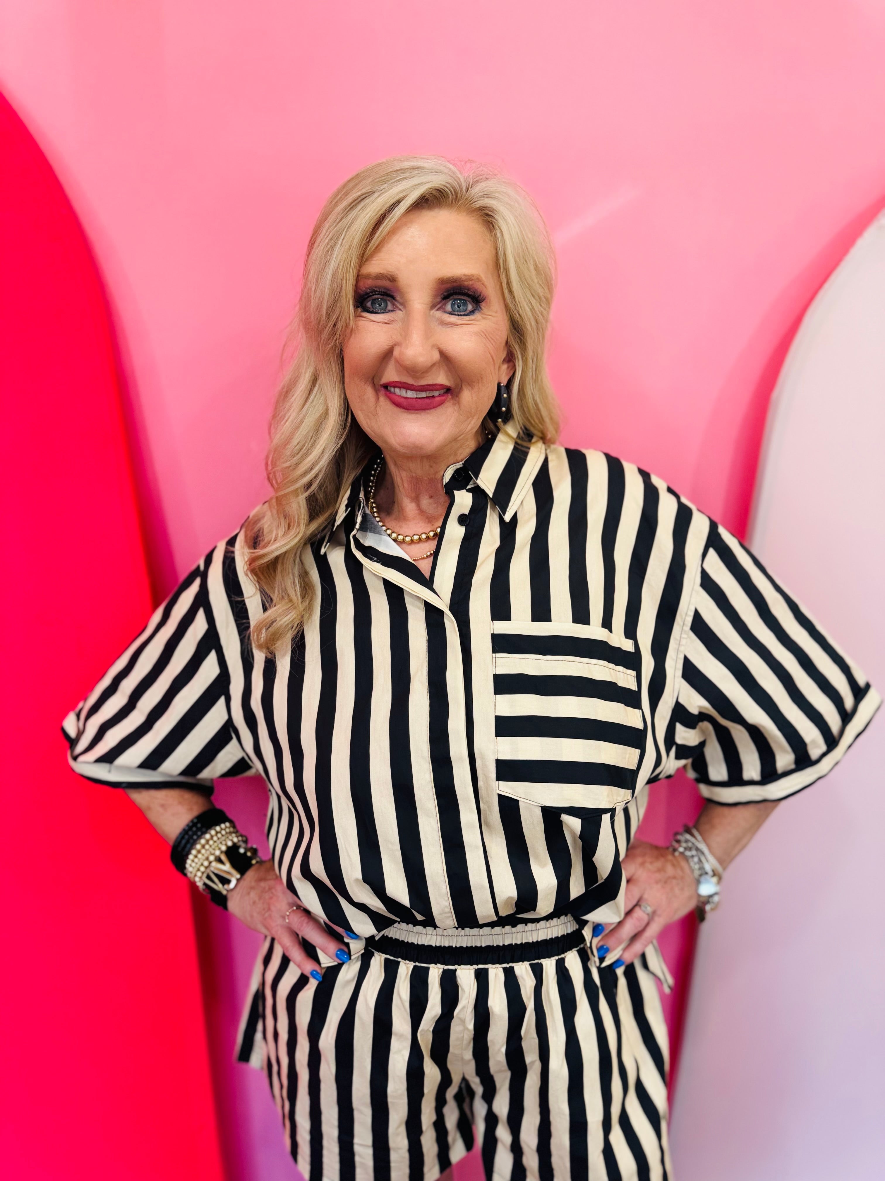 Black and ivory striped button down top with collar and contrast pocket detail.