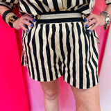 Black and white striped cotton shorts with elastic waistband and relaxed fit.