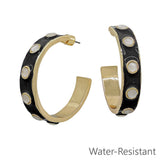 Black coated 2 inch hoop earrings with cream accents featuring water resistant design.