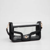Clear black game day shoulder bag with gold hardware, removable strap, and magnetic closure.