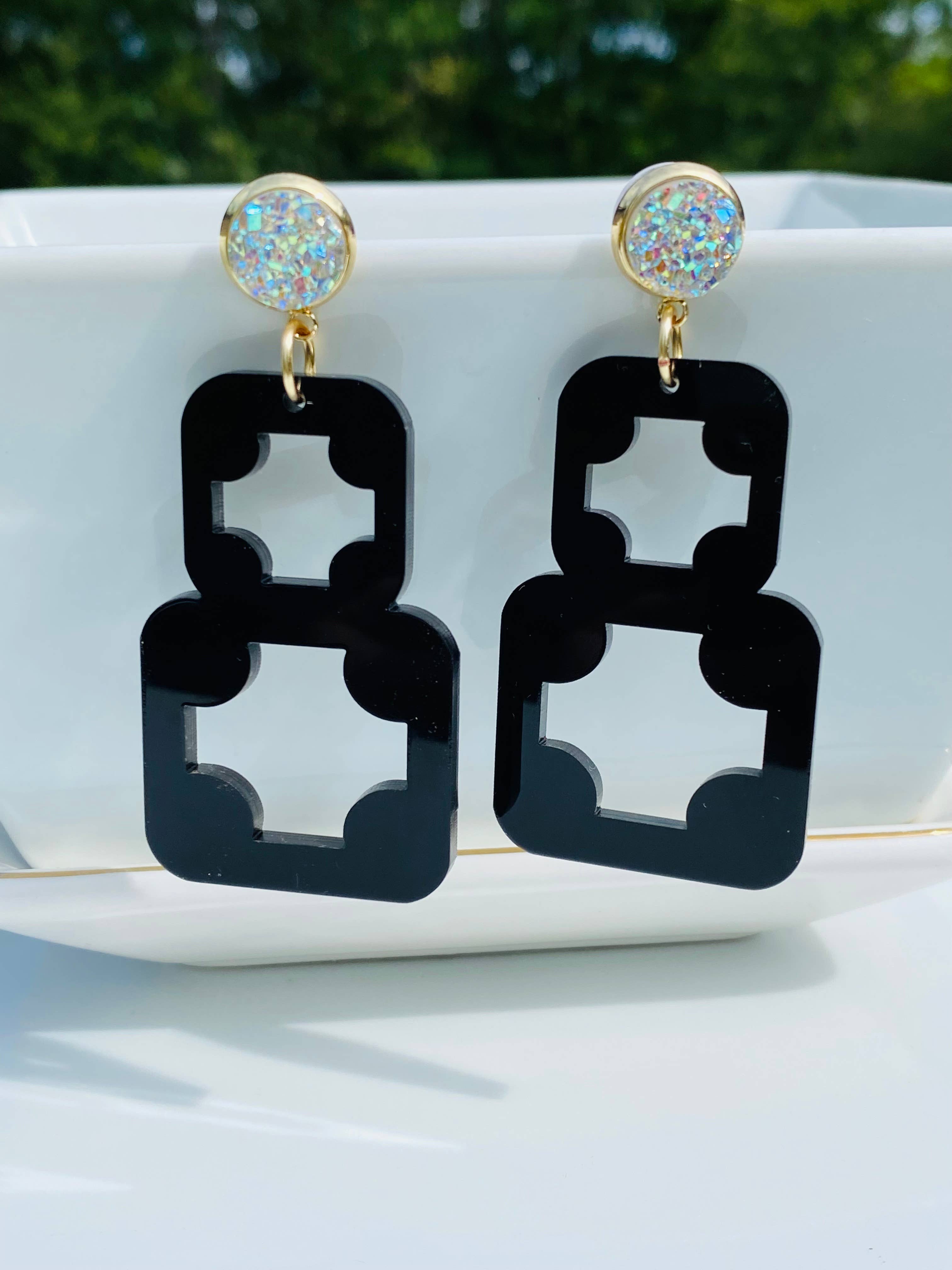 Black geometric acrylic earrings with AB druzy studs and gold-plated accents.