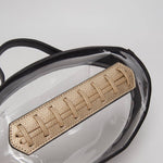 Black football crossbody bag with gold stitching, gold hardware, top handle, and adjustable strap.