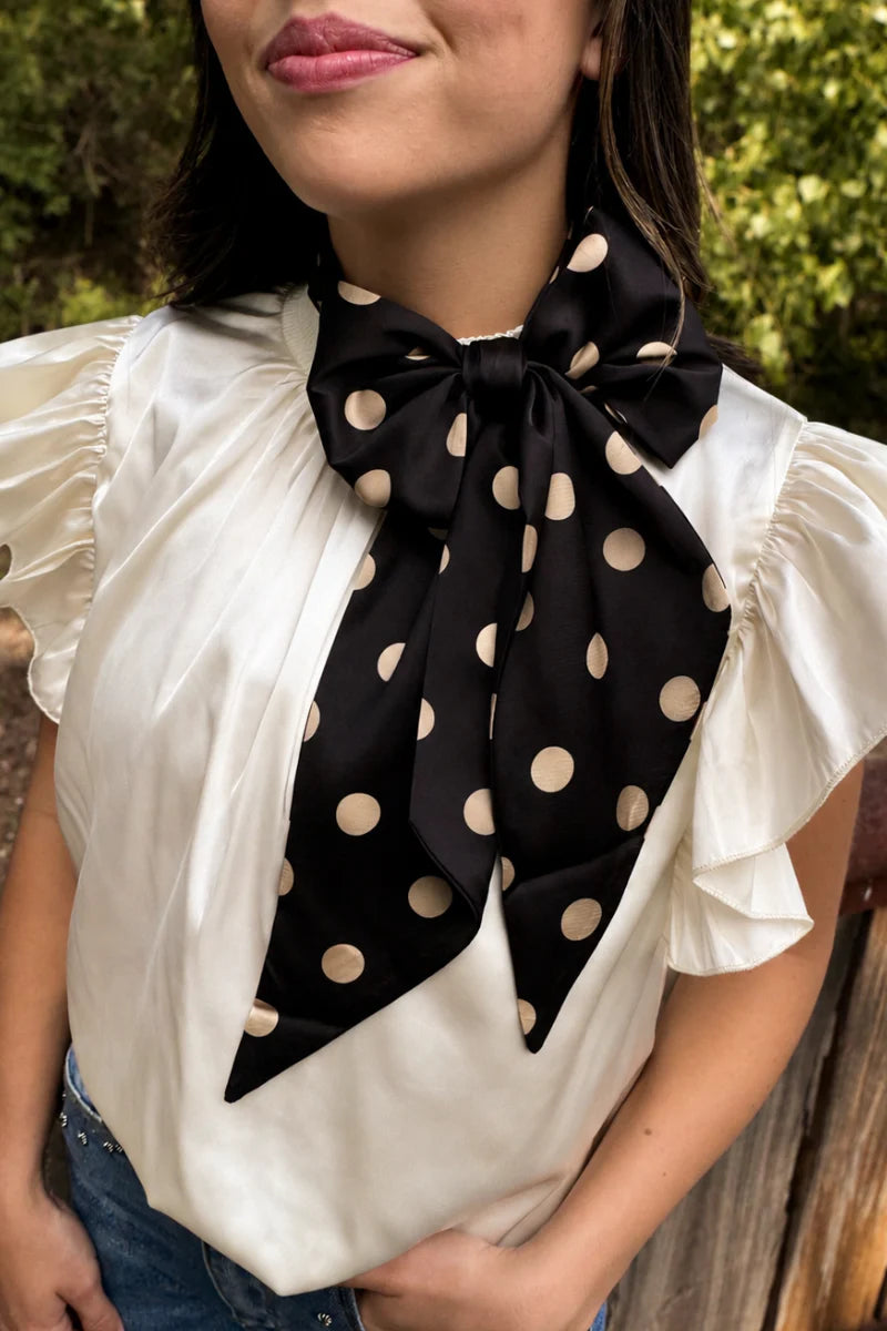 Black and gold silky polka dot scarf with versatile styling options.