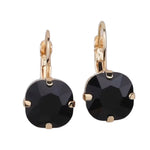 Gold tone drop earrings with faceted black gemstone and fishhook ear wire.