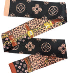 Black 47 inch scarf with leopard boujee print and chain link design styled as necklace