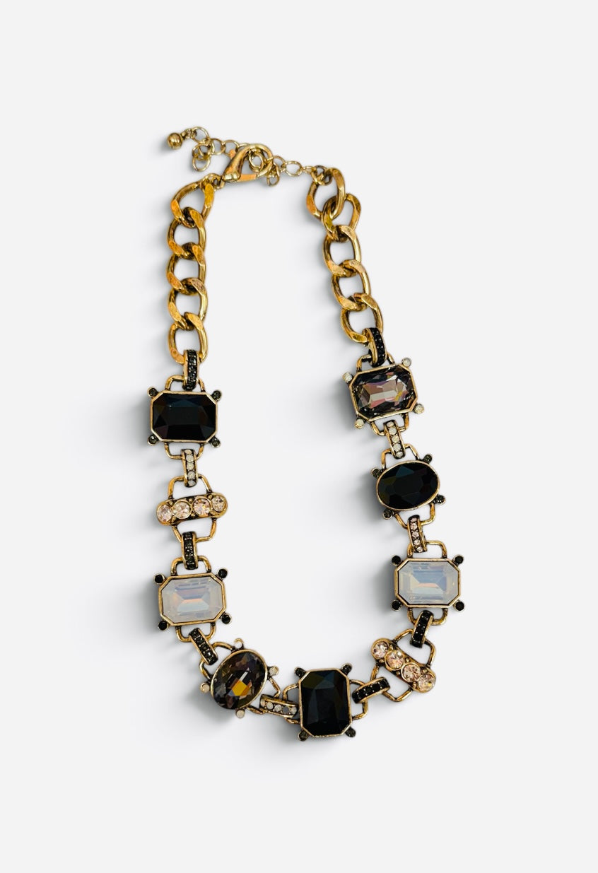 Chunky gold-tone link necklace with black, smoky, clear crystals and rhinestone accents.