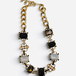 Chunky gold-tone link necklace with black, smoky, clear crystals and rhinestone accents.