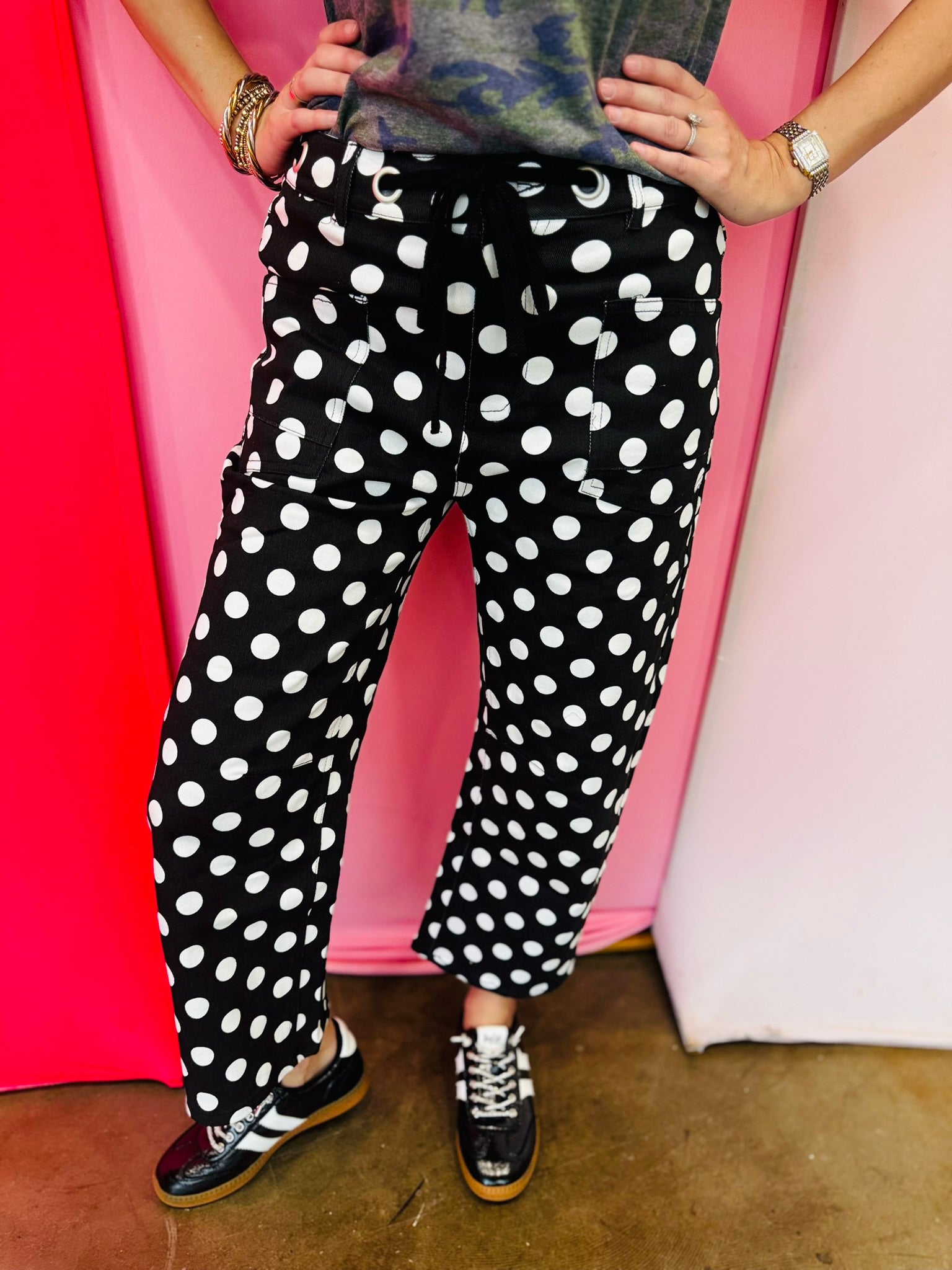 Black and white polka dot cropped barrel pants with drawstring waist and pockets.