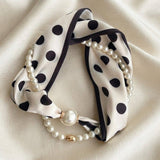 Black and white polka dot scarf necklace with lustrous pearl accents.