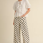 White wide-leg pants with black polka dots, hidden zipper closure, back stretch waistband, and side pockets.