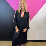 Black half-zip maxi dress with red, cream, and tan stripes and long sleeves.