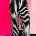 Black and white striped wide leg pants with elastic waistband and pockets.