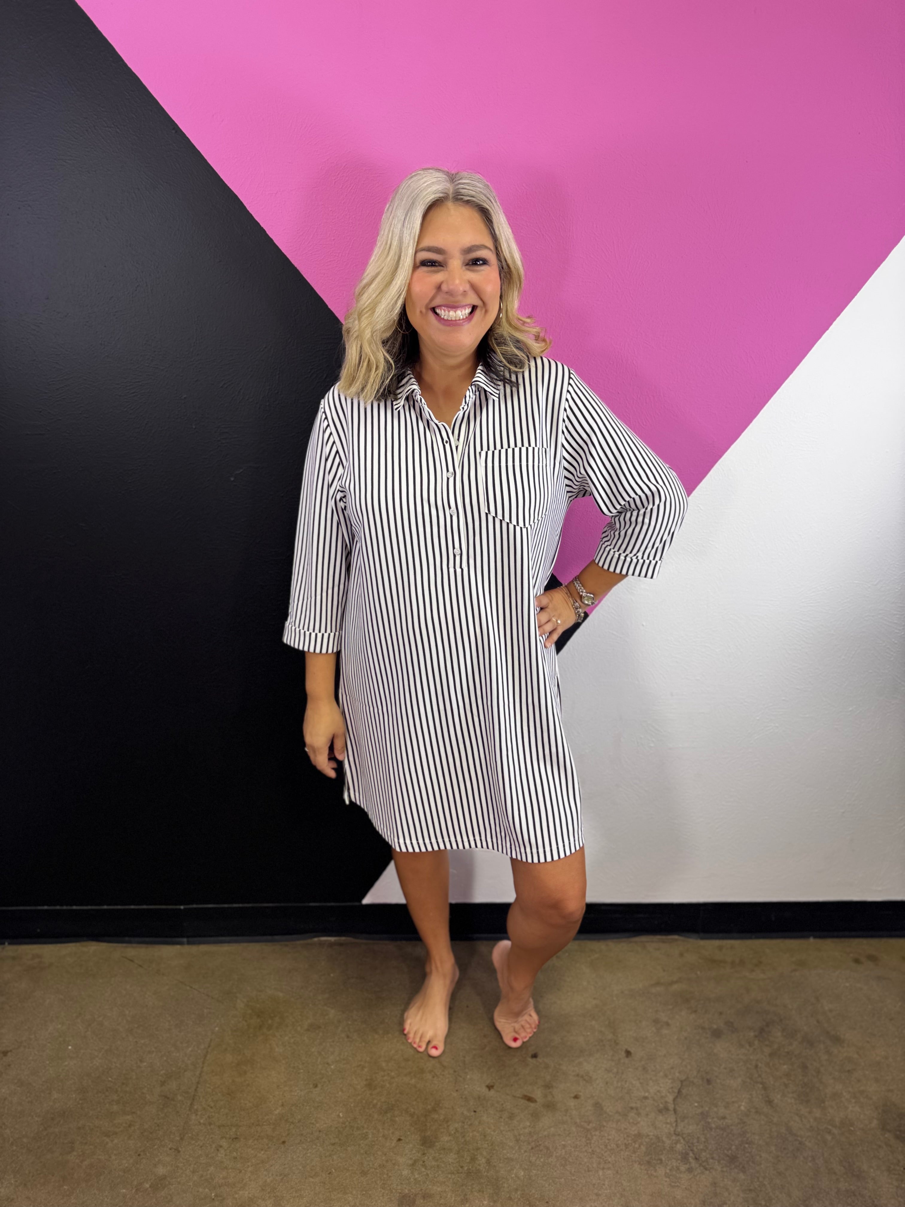 Black striped collared shirt dress with button front, chest pocket, and three-quarter sleeves