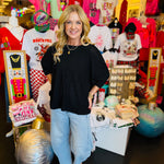 Black waffle knit top with boxy fit, raw seam, 3/4 sleeves, and longer back.