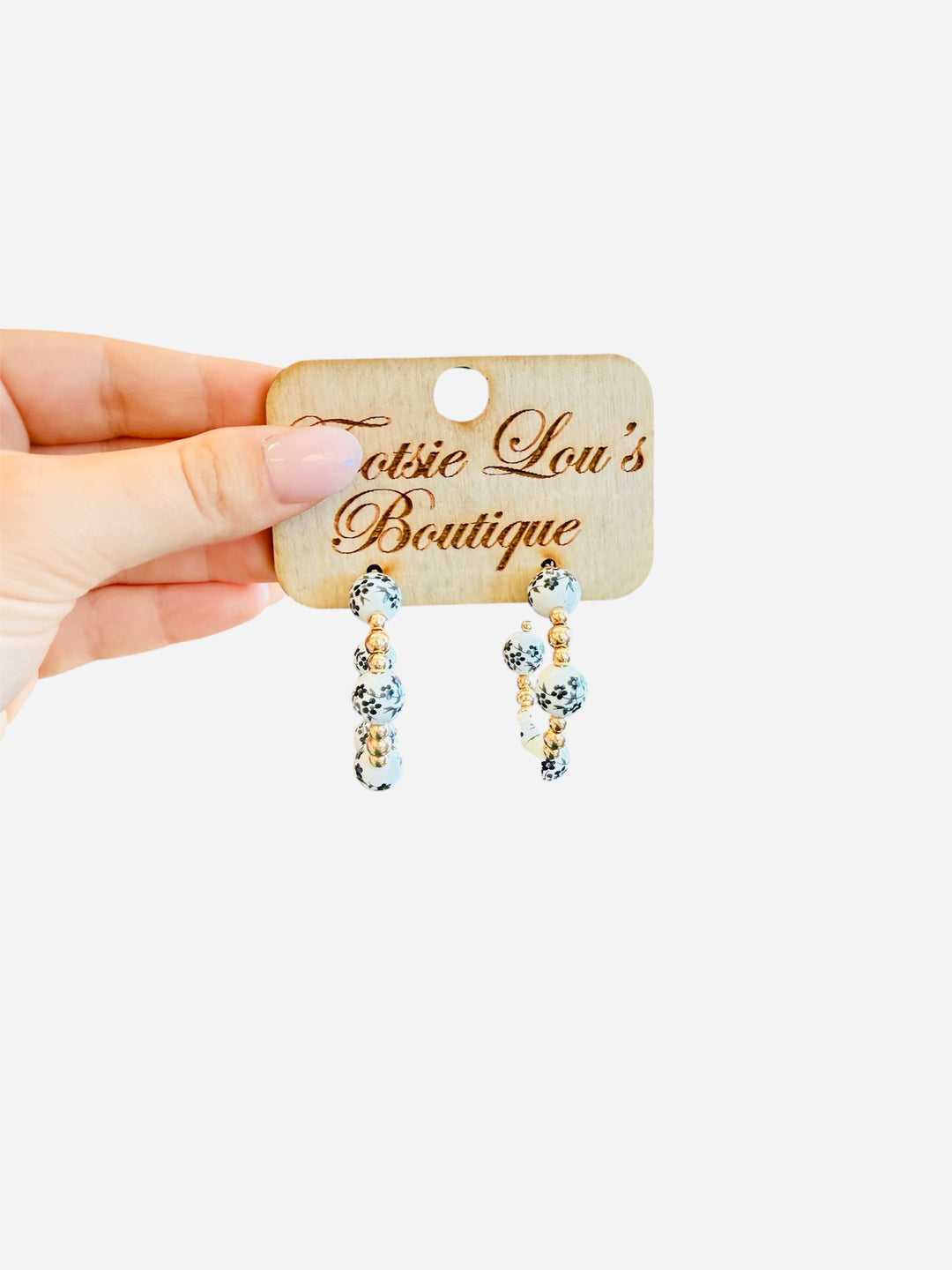 Water-resistant Chinoiserie hoop earrings with black, white, and gold beads.