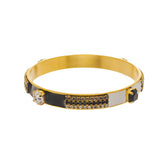 Black and white enamel bangle with crystal accents and antique gold finish