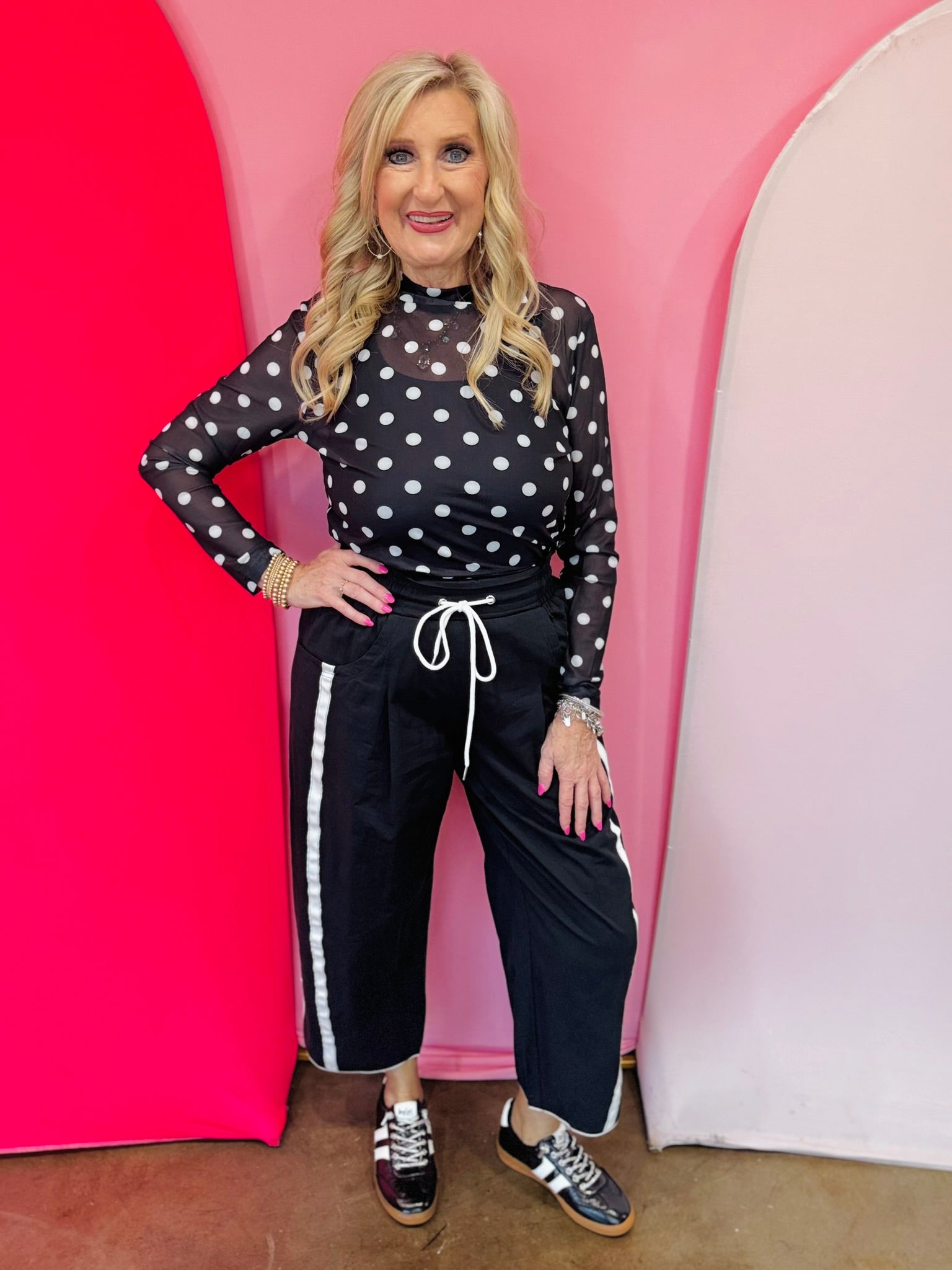 Black mesh top with white polka dots and mock neckline.2