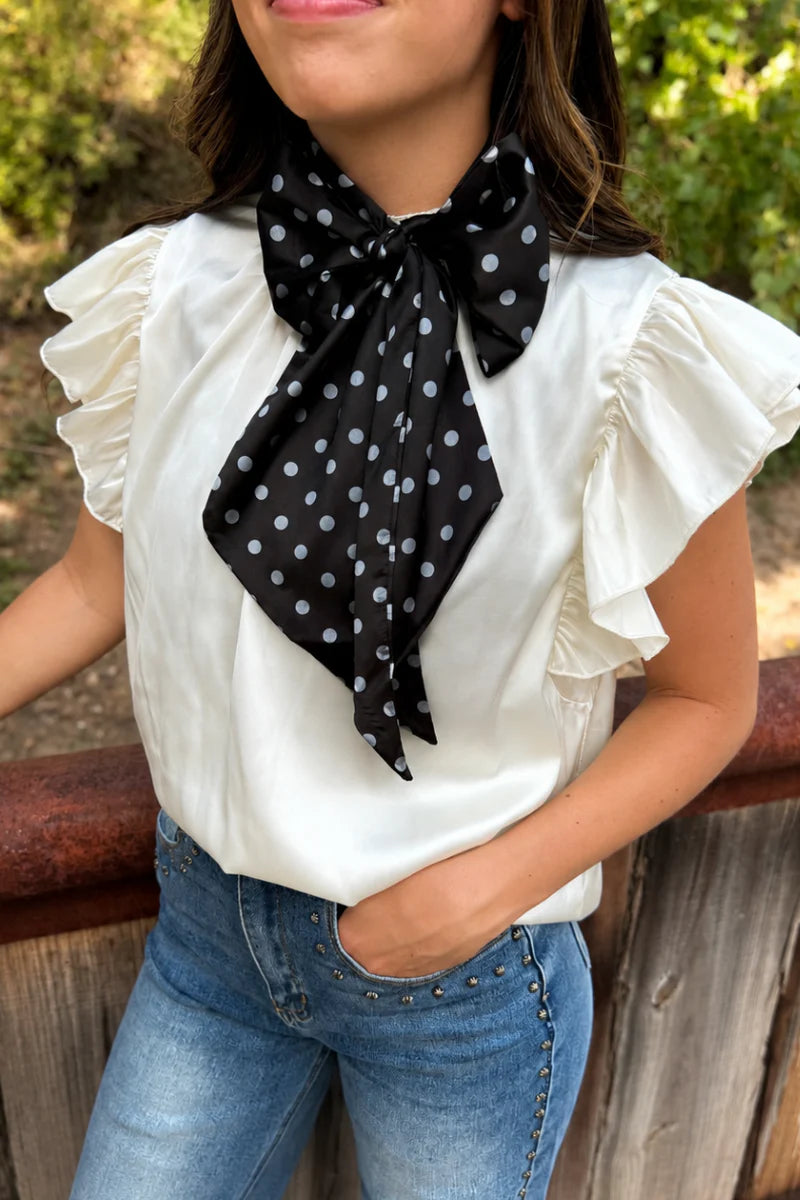 Black and white silky polka dot scarf with versatile styling options.
