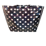 Black PVC tote bag with white polka dots, sturdy handles, interior pockets, and Velcro closure.
