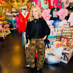 Camo print barrel jeans with mid-rise fit, tapered ankle, knee darts, and detailed side seams.