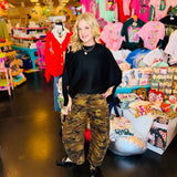 Camo print barrel jeans with mid-rise fit, tapered ankle, knee darts, and detailed side seams.