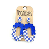 Blue checkered acrylic dangle earrings with hypoallergenic stainless steel settings.