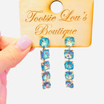 Gold-tone drop earrings with cascading iridescent blue crystals.