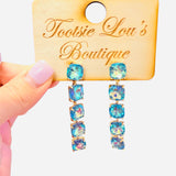 Gold-tone drop earrings with cascading iridescent blue crystals.