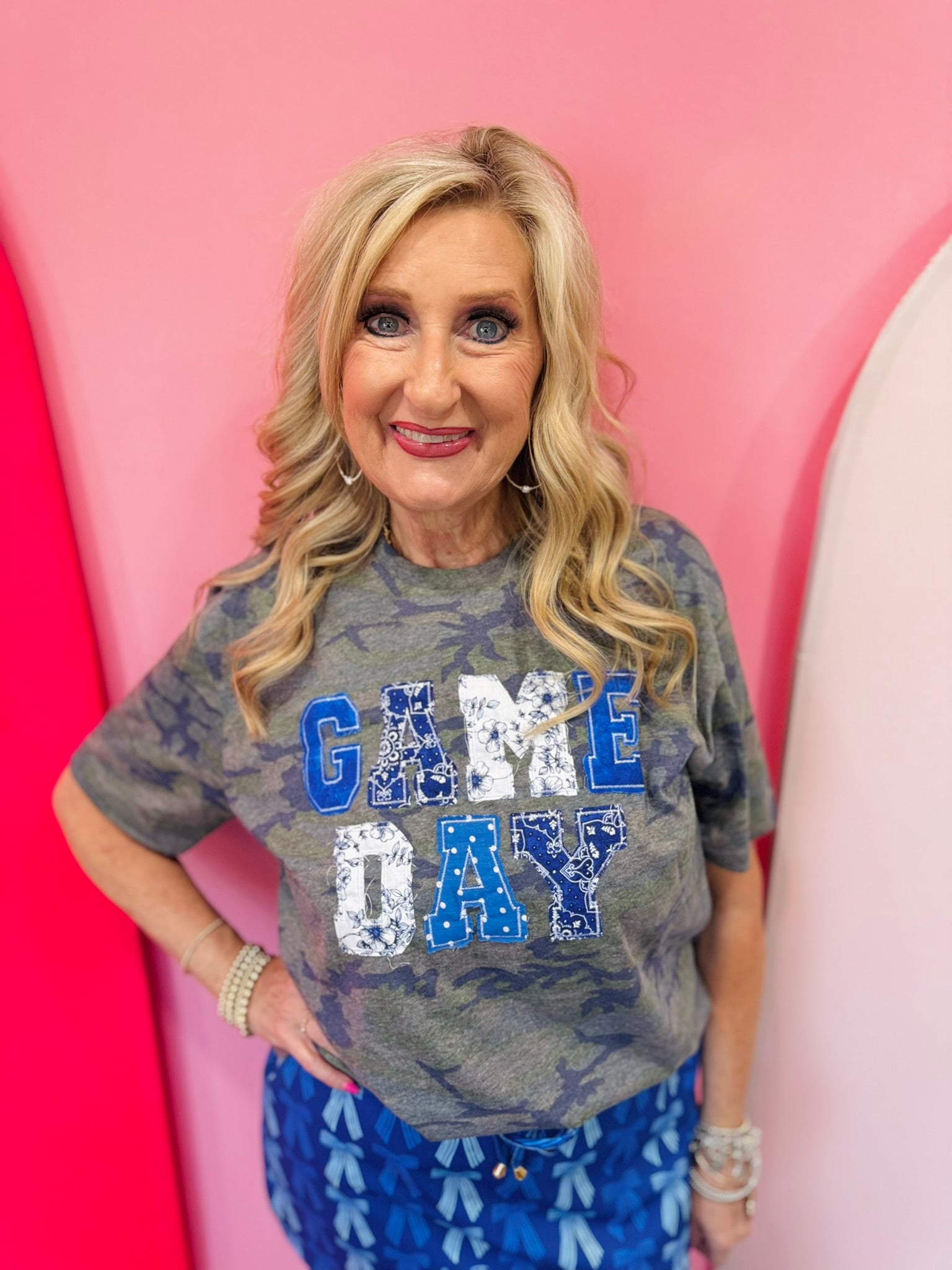 Blue Game Day tee with patchwork appliqué lettering and mixed blue print details.