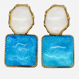 Blue and pearl gold-tone resin dangle earrings