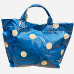Blue polka dot tote bag with shiny finish and white dots.