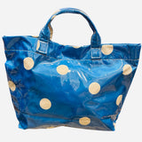 Blue polka dot tote bag with shiny finish and white dots.