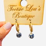 Gold hoops with dangling blue and white porcelain-inspired charm beads.