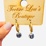 Gold hoops with dangling blue and white porcelain-inspired charm beads.