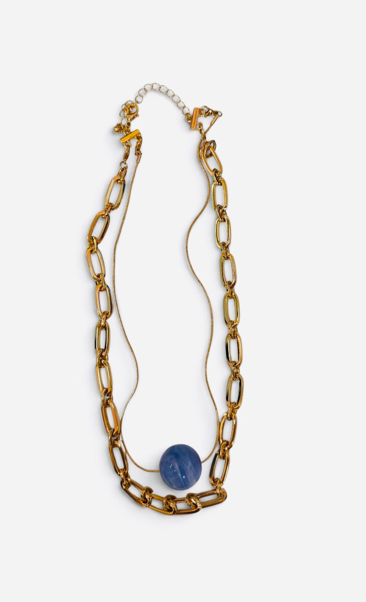 Layered gold paperclip chain necklace with smooth marbled blue stone centerpiece.