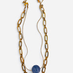 Layered gold paperclip chain necklace with smooth marbled blue stone centerpiece.