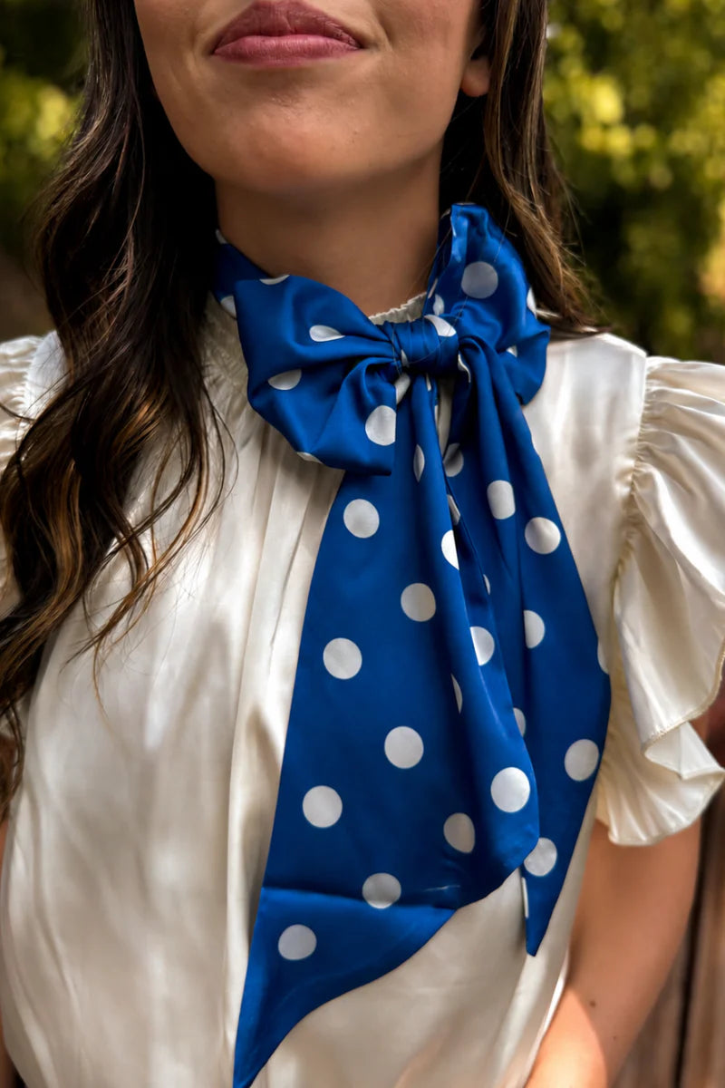 Blue and white silky polka dot scarf with versatile styling options.