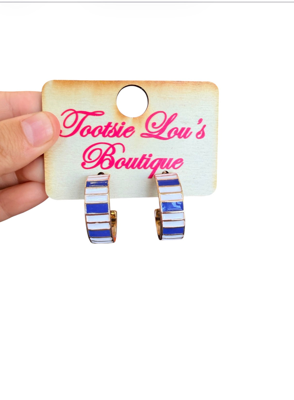 Blue and white striped enamel hoop earrings with polished gold-tone finish.
