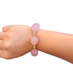 Blush pink bubble bracelet with oversized glossy beads and gold accents.