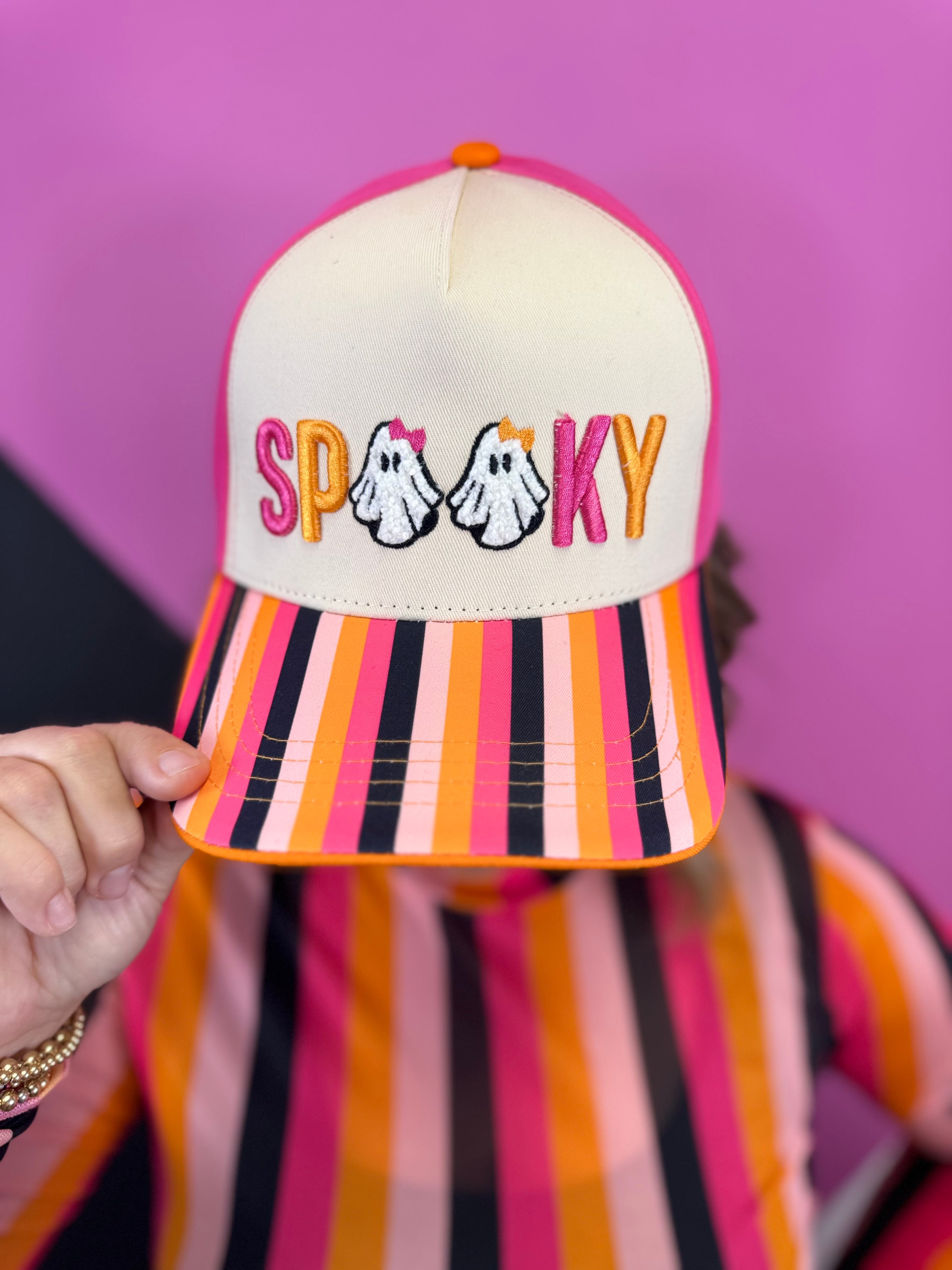 Cream Halloween hat with colorful SPOOKY embroidery, ghosts, bows, and multicolor striped bill.