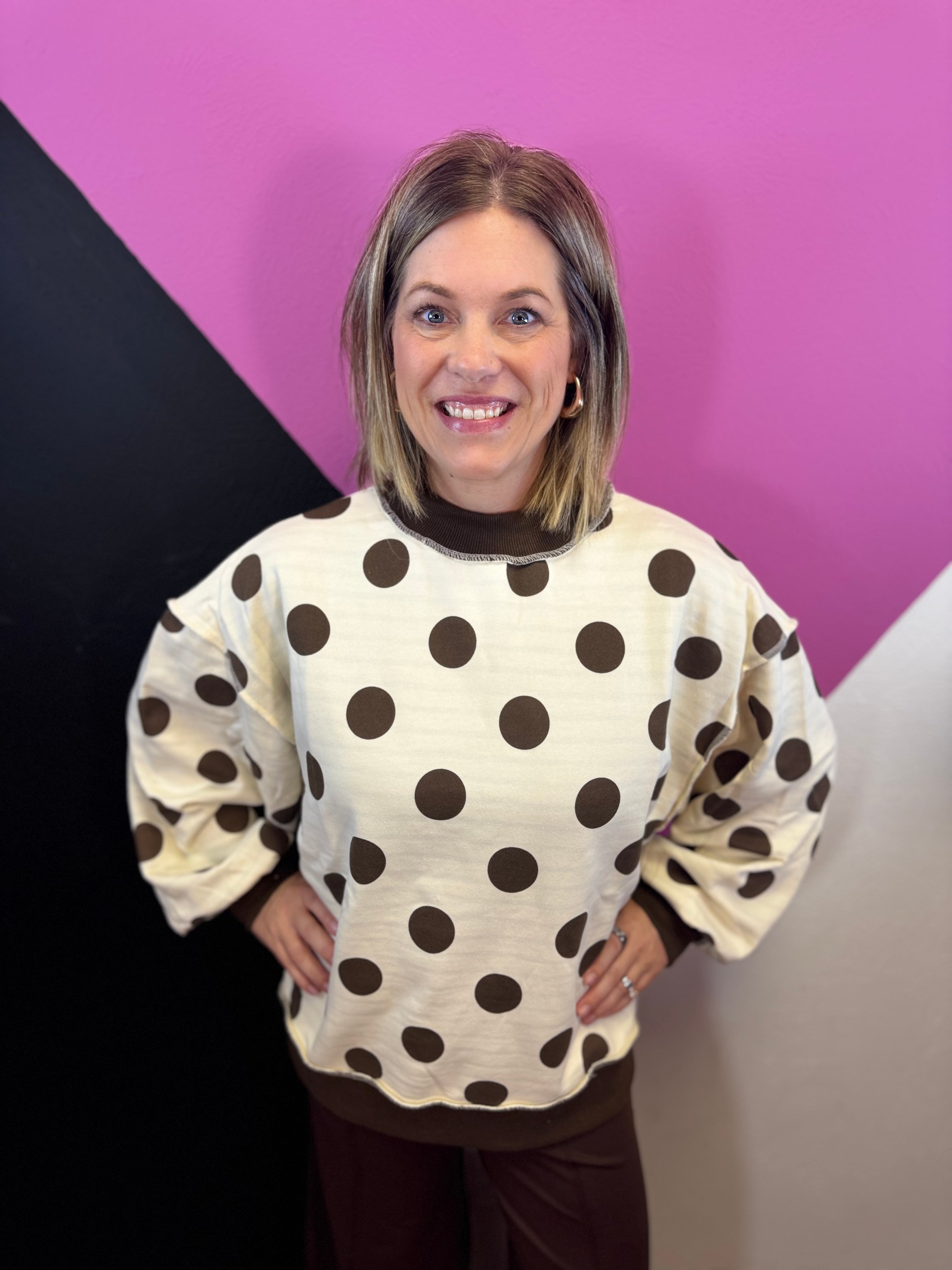 Brown and ivory reversible sweatshirt with polka dot and stripe patterns and mock neckline.