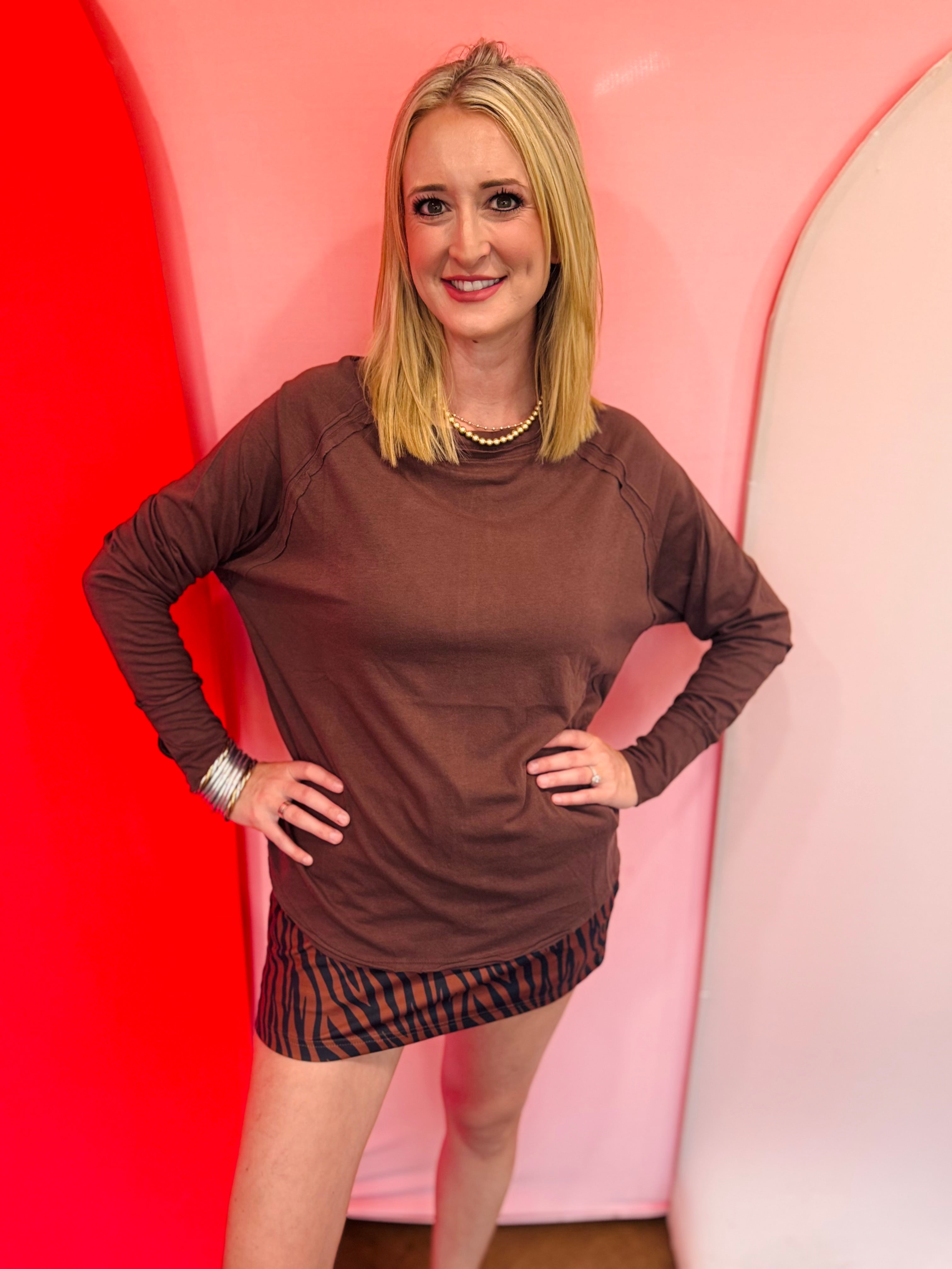 Brown cotton raglan top with thumbhole cuffs.