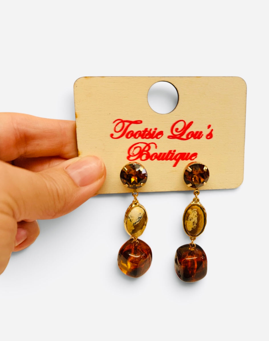 Brown and tan gemstone drop earrings with glossy beads and polished gold-tone settings.
