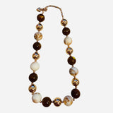 Caramel and ivory beaded necklace with marbled details and gold accent beads