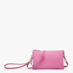 Bubblegum pink crossbody bag with multiple compartments and adjustable strap in vegan leather