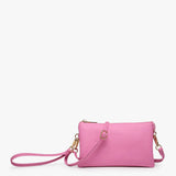 Bubblegum pink crossbody bag with multiple compartments and adjustable strap in vegan leather