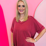 Burgundy corded rib knit top with hi-low V-neck and short sleeves
