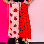 Half pink ladybug and half red polka dot cropped pants with elastic waistband.