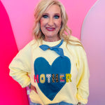 Butter yellow oversized Mother sweatshirt with denim heart patch lettering.
