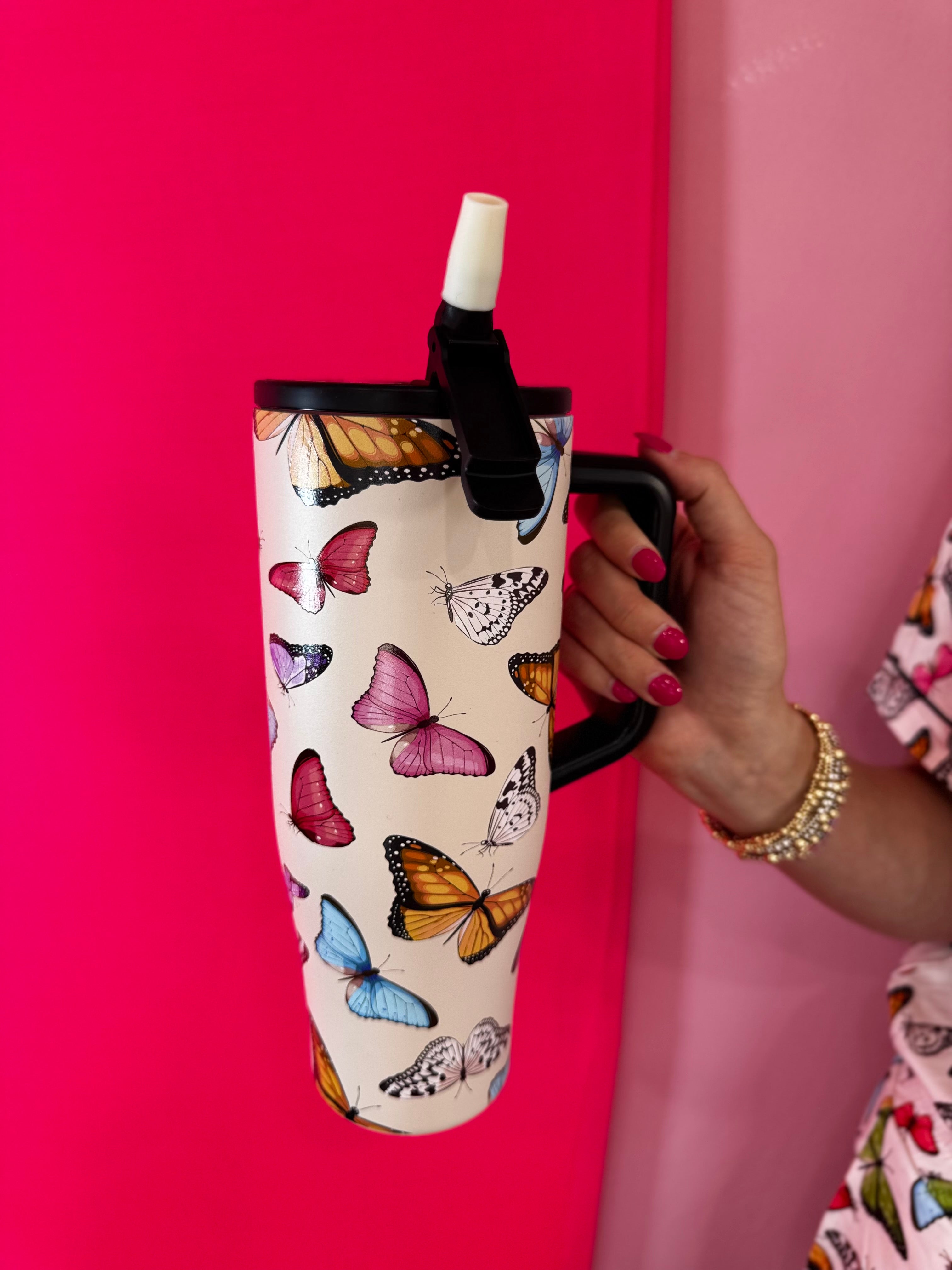 40oz butterfly print tumbler with flip straw lid and handle.